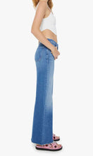 Load image into Gallery viewer, Woman standing, side view,  wearing Mother Denim The Roller Fray jeans, in colour Work Hard Play Hard, available at Amara Home.
