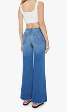 Load image into Gallery viewer, Woman standing, back view,  wearing Mother Denim The Roller Fray jeans, in colour Work Hard Play Hard, available at Amara Home.
